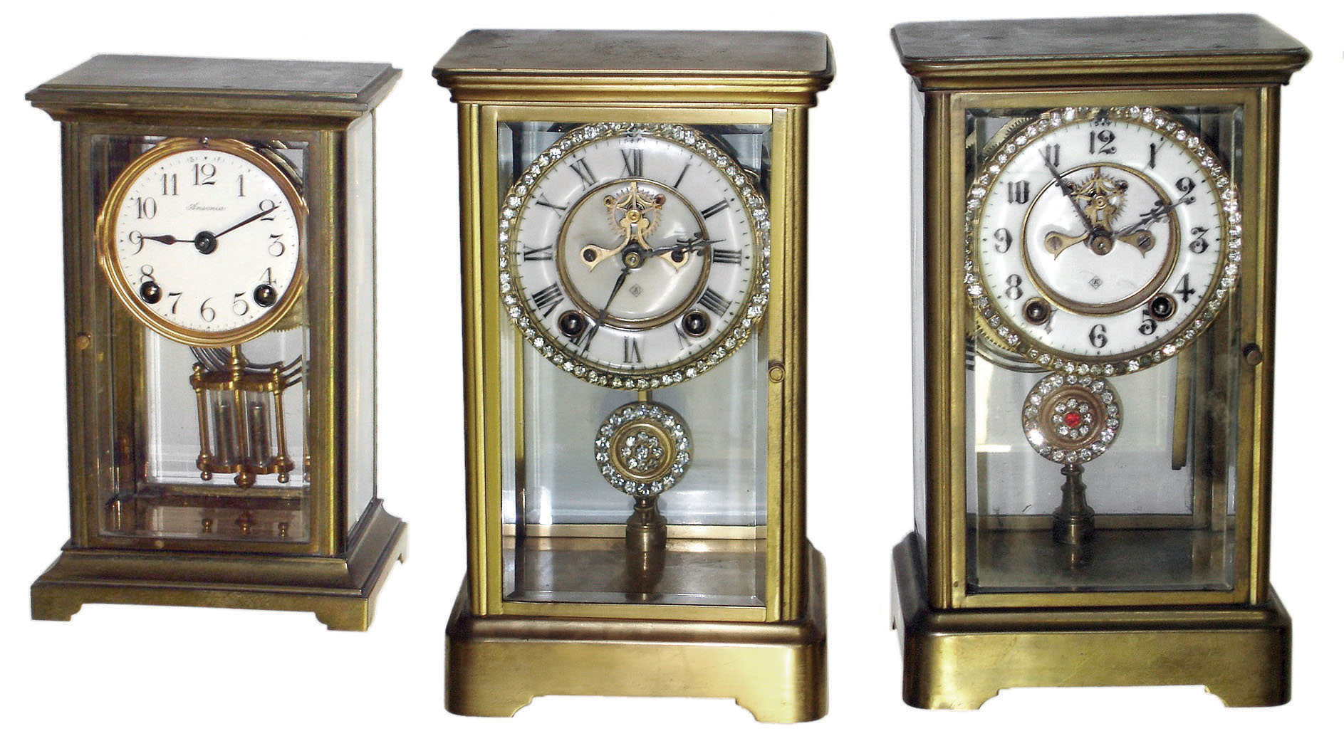 Clocks- 3 (Three): Ansonia Clock Co., crystal regulator 8 days, time and strike, brass and glass mantel clocks: two "Prism" models with visible escapements and "Jeweled Sash" rhinestone bezels and pendulums: one "Dorval" smaller size — Antique Clocks Price Guide