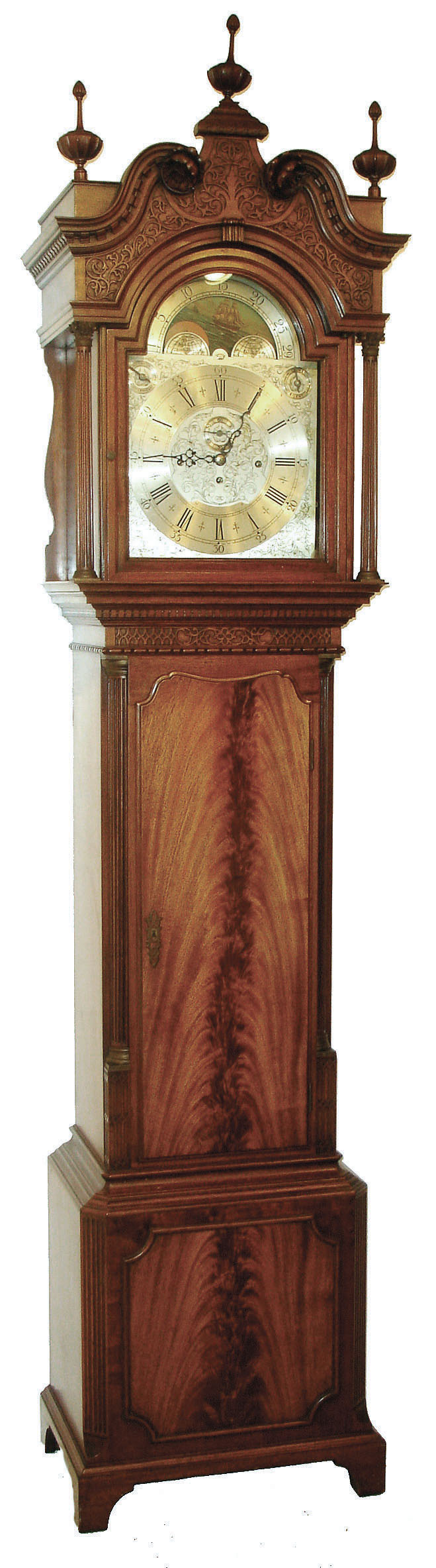 Herschede Clock Co., Cincinnati, Ohio, custom 9 tube hall clock, 8 day time, strike &amp; chime, three weight driven movement playing three tunes, Westminster, Wittington, Canterbury in a mahogany case with fluted Corinthian quarter columns on trunk and base, bracket feet, crotch mahogany panels on door and base, carved relief work on arch above dial and above door and full fluted columns with brass Corinthian tops and bases. The broken arch top has carved floral rosettes, dental molding and fine cup finials. The silvered engraved dial has wax filled Roman numerals on an applied chapter ring and moon phase, c1921 — Antique Clocks Price Guide