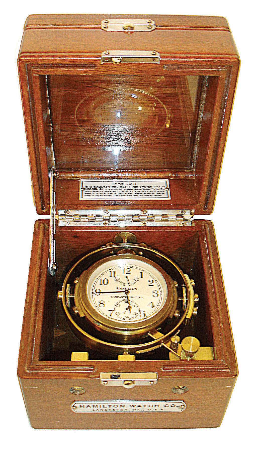 Hamilton Watch Co., Lancaster, Penn., model 22 chronometer with wind indicator, 35 size, 21 jewels, stem wind, pin/stem set, adjusted to 6 positions and temperature, straight line damascened nickel plate movement, with lever escapement and micrometric regulator, movement marked "U.S. Navy Bu. Ships - 1942", Arabic numeral metal dial and black steel, spade and poker hands, in a gimbaled bowl, contained in a mahogany box with name plate on front, serial #2F5655, c1942. — Antique Clocks Price Guide