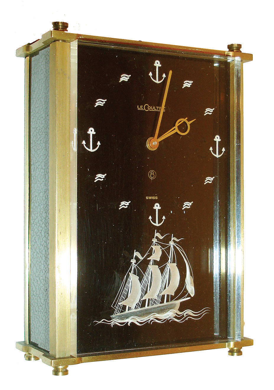 Jaeger - LeCoultre, Switzerland, small desk or nightstand clock, model# 2163, rectangular brass case with brushed finish, lucite front with wave and anchor hour markers, and with 3 dimensional tall ship below, dial signed "LeCoultre Swiss", gilt hands, case sides with black panels, 8 day time and alarm movement, with separate music box playing 2 tunes, c1965 — Antique Clocks Price Guide