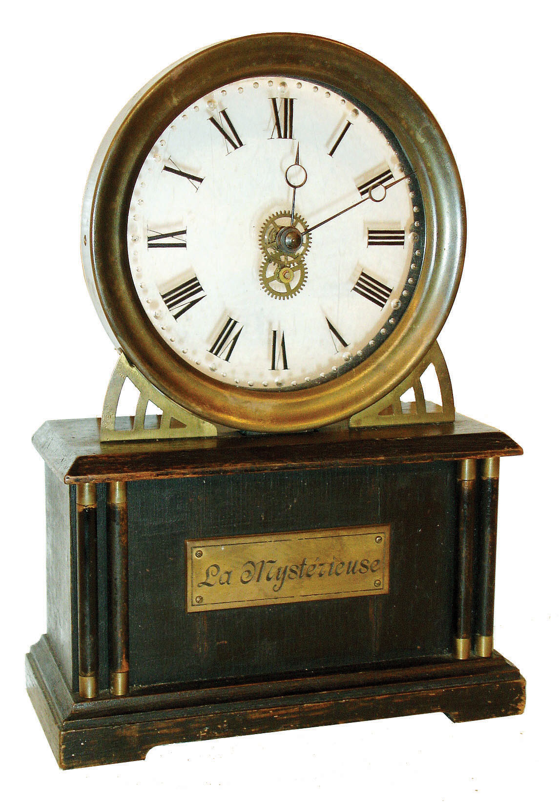Hamburg American Clock Co., Germany, "La Mysterieuse", desk clock with transparent dial, and no apparent connection to the movement, ebonized wooden case with engraved plaque, Roman numeral see through dial mounted in a molded brass bezel, blued steel Breguet style hands, 30 hour lever movement concealed in the clock base, c1920 — Antique Clocks Price Guide