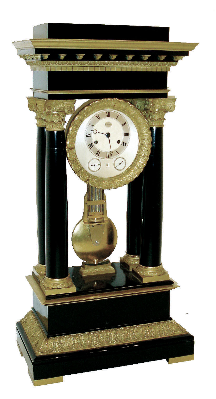 French, L. Dubois [Paris], extra large 4-column Empire style portico clock with day and month subsidiary dials, and with an aperture below six for the date, bell striking 15 day movement, numbered 435, the case of ebony veneers and ebonized wood, accented with heavy ormolu capitals and moldings, C.1860 — Antique Clocks Price Guide