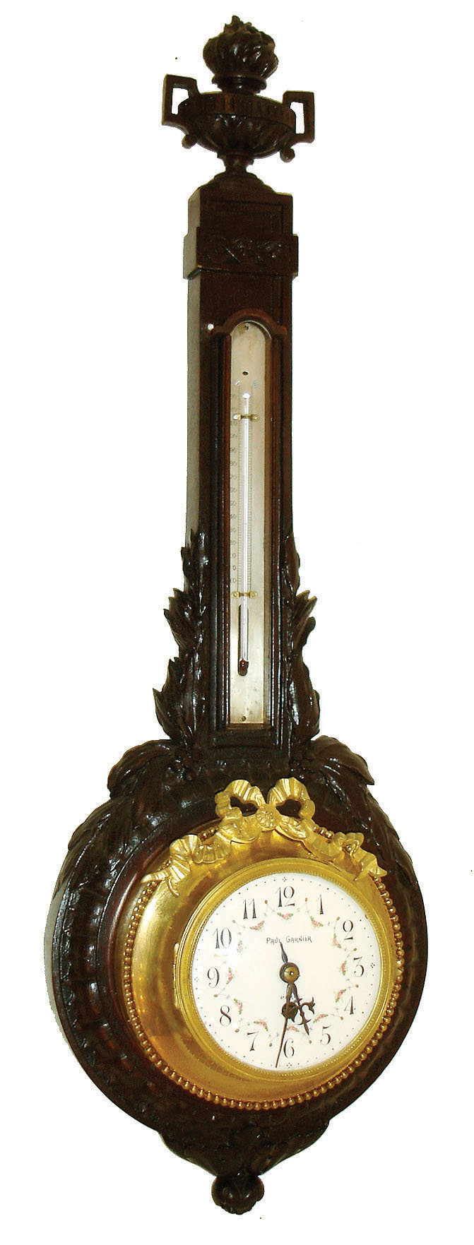 Paul Garnier, Paris, wall clock with thermometer, dark oak case with carved laurel and the top with an urn, the upper section with thermometer, the lower with gilt cased timepiece, signed Arabic numeral white enamel dial with polychrome floral swags, blued steel hands, 8 day time only, movement with platform escapement, c1910 — Antique Clocks Price Guide