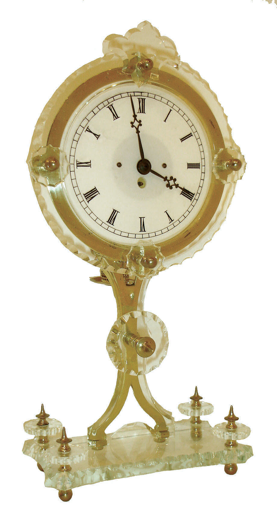 E.G. Zimmerman, Frankfurt, Germany, 30 hours, timepiece movement night clock, the case of transparent glass with cut edge decoration, supported by a polished brass frame and with turned brass feet and decorative finials, candle holder at center of back for dial illumination, Roman numeral translucent glass dial, blued steel hands, the movement barrel bridge marked "E.G. Zimmermann Frankfurt AM", c1880 — Antique Clocks Price Guide