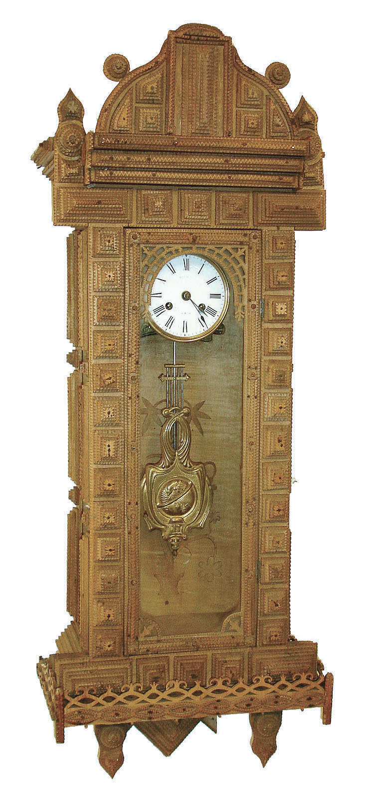 Tramp art clock case with spring Vienna movement, the case composed of chip carved and pierced graduated blocks stacked to create a very busy 3 dimensional effect, backboard with inlaid vine with flowers, case sides with decorative frosted glass panels, Roman numeral white enamel dial with illegible signature, brass 8 days, time and strike, movement, and brass and steel gridiron style pendulum in the Art Nouveau style, c1930 — Antique Clocks Price Guide