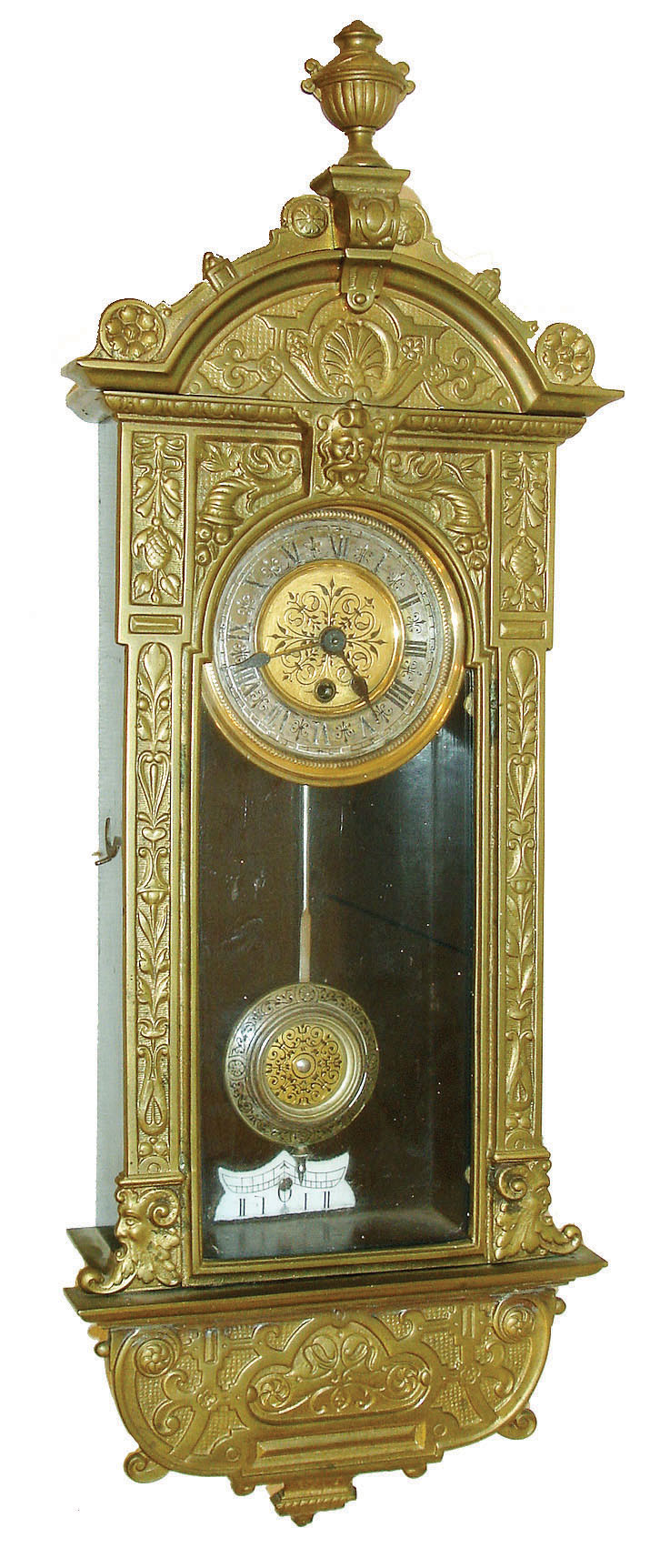 Rudolf Mayer, Germany, miniature Vienna style 8 days, timepiece, cast brass ornamental front attached to a wooden case with enamel beat scale, arch top with finial, back of top signed "Rud. Mayer Fec" and with his trade mark, glazed door with arched aperture, Roman numeral silvered dial with embossed, ornamented gilt center, the pendulum with matching embossed decoration, blued steel hands, brass timepiece movement with dead beat escapement, c1900 — Antique Clocks Price Guide