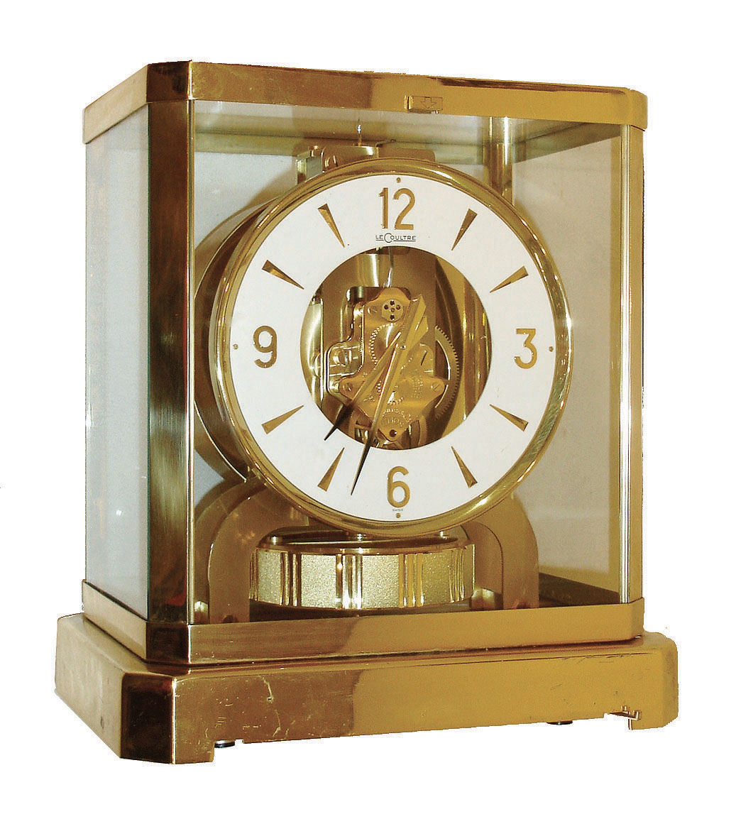 Jaeger - LeCoultre, Switzerland, "Atmos" clock, 15 jewel gilt caliber 528 movement, gilt torsion pendulum, round white painted dial with applied gilt Arabic numerals and arrow markers, gilt hands with black painted tips, all contained in a glazed rectangular case with removable front panel, serial #328795 — Antique Clocks Price Guide