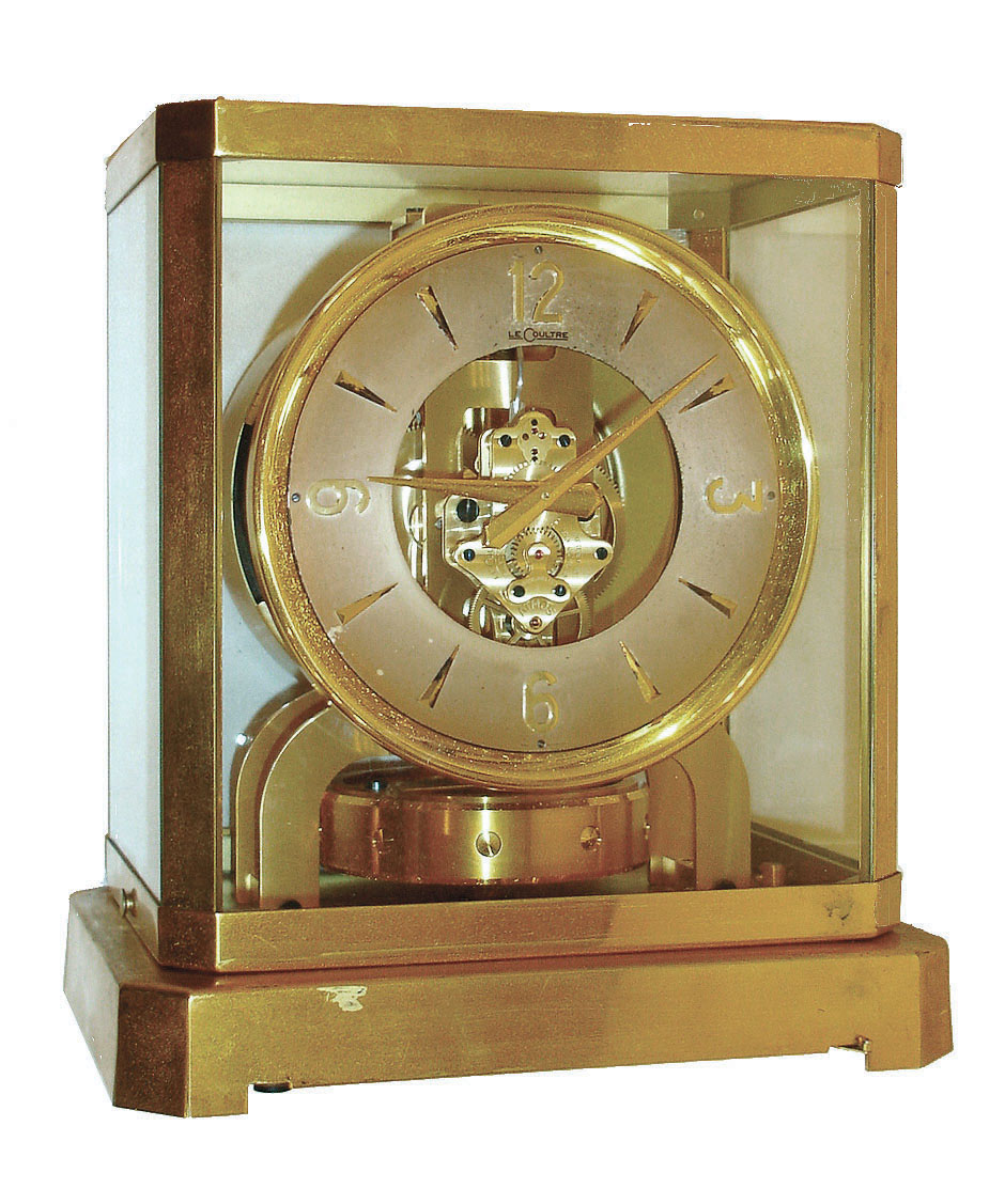 Jaeger - LeCoultre, Switzerland, "Atmos" clock, 15 jewel gilt caliber 529 movement, gilt torsion pendulum, round silvered dial with applied gilt Arabic numerals and arrow markers, gilt hands, all contained in a glazed rectangular case which can be lifted from the base, serial #69998 — Antique Clocks Price Guide