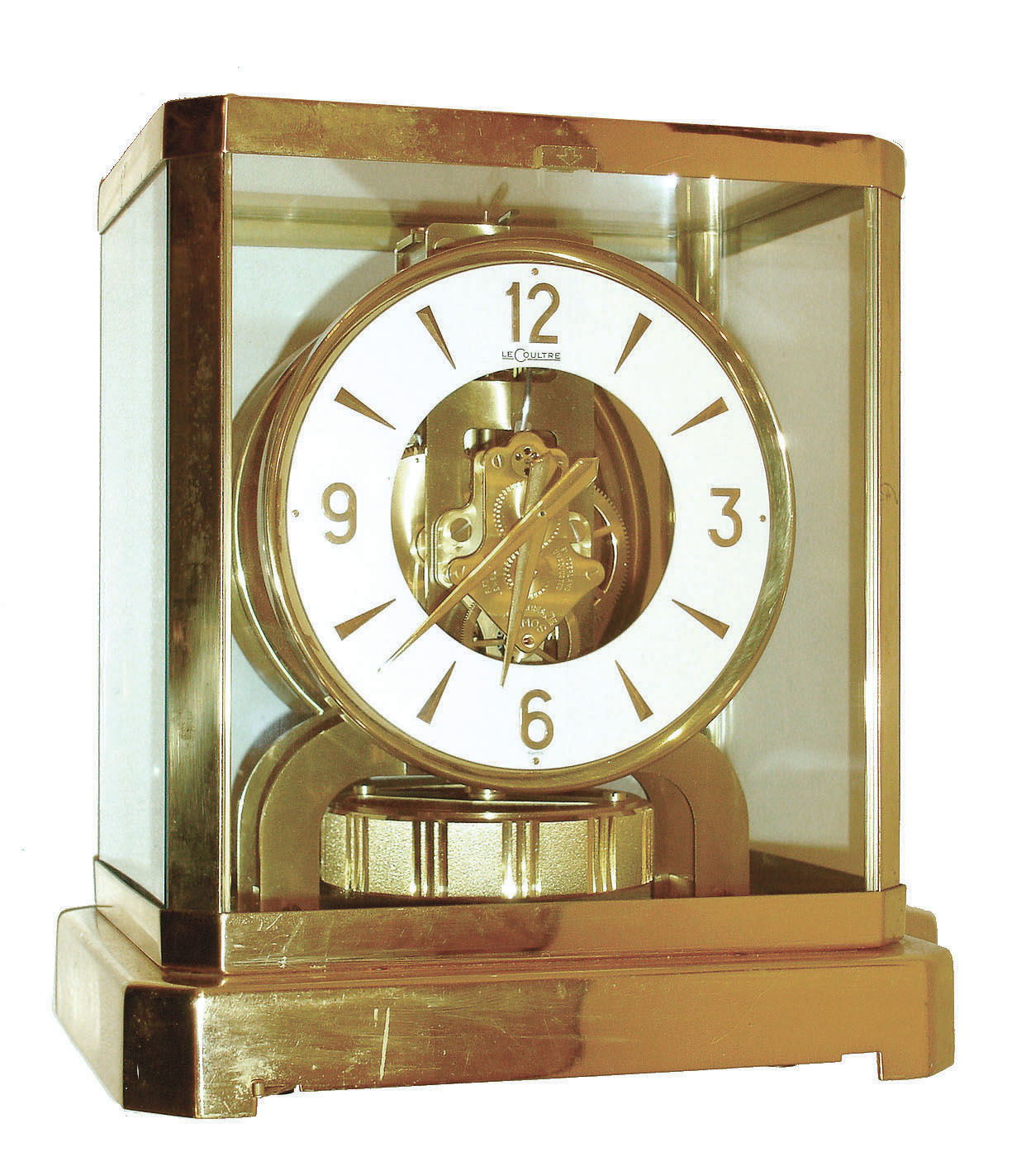 Jaeger - LeCoultre, Switzerland, "Atmos" clock, 15 jewel gilt caliber 528 movement, gilt torsion pendulum, round white painted dial with applied gilt Arabic numerals and arrow markers, gilt hands, all contained in a glazed rectangular case with removable front panel, serial #368346 — Antique Clocks Price Guide