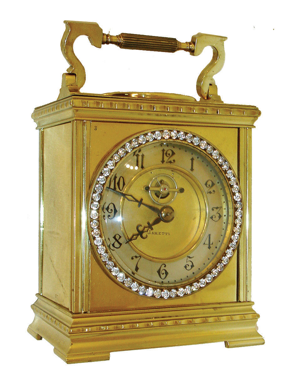 France, 8 days, time only, carriage clock with heavy, polished brass case with carrying handle, the top set with a thermometer &amp; compass, the front with brilliant set bezel, Arabic numeral silvered dial with gilt, sunken center signed "Janetti", the exposed 3-spoke balance oscillating below 12:00, blued steel hands, c1910 — Antique Clocks Price Guide