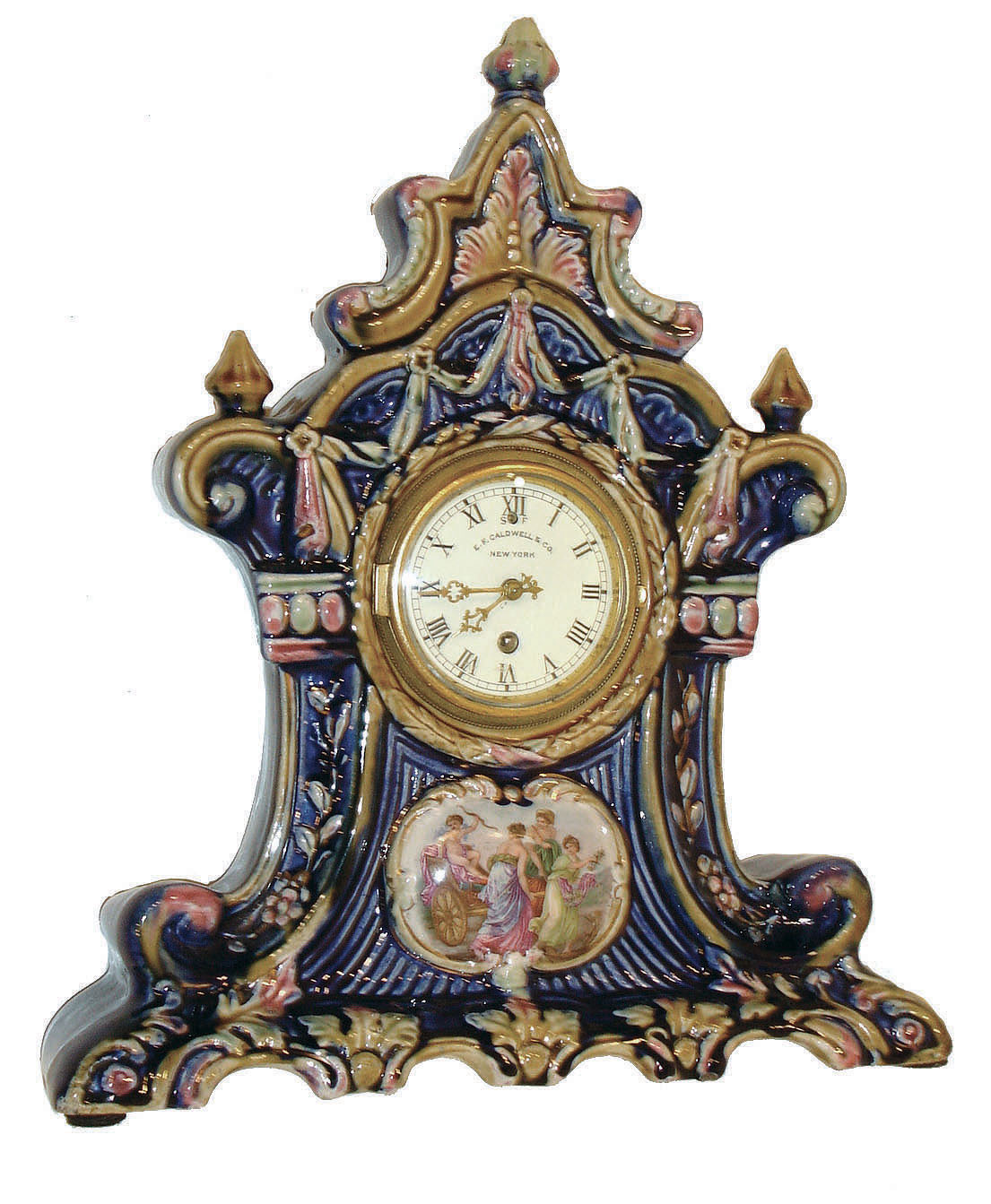 Chelsea, and E.F. Caldwell &amp; Co., New York, majolica style clock case with cobalt blue ground, and multicolor ornament, with enamel painting of cupid in his chariot and three female figures, gilt bezel with convex glass, Roman numeral white enamel dial, pierced gilt hands, and Chelsea 8 days, time only, movement with watch escapement, serial #171669, c1925 — Antique Clocks Price Guide
