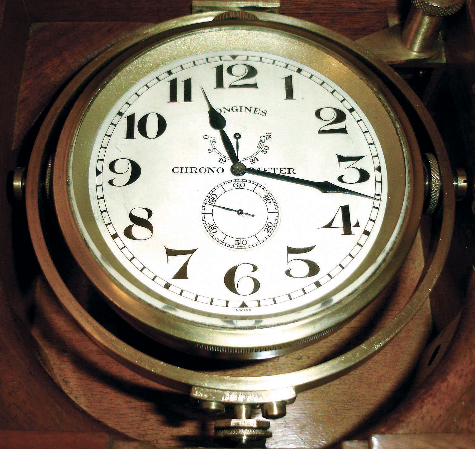 Longines, Switzerland, lever escapement chronometer with boxes, outer mahogany protective case containing the brass mounted, gimbaled box, the lid with plaque stating "Longines Chronometer Showing Observatory Time to the second", timepiece mounted in a weighted brass bowl, Arabic numeral silvered dial with wind indicator, blued steel spade and poker hands, 17 jewel caliber 21.29 movement with lever escapement and bimetallic balance, serial #6411684, c1910 — Antique Clocks Price Guide