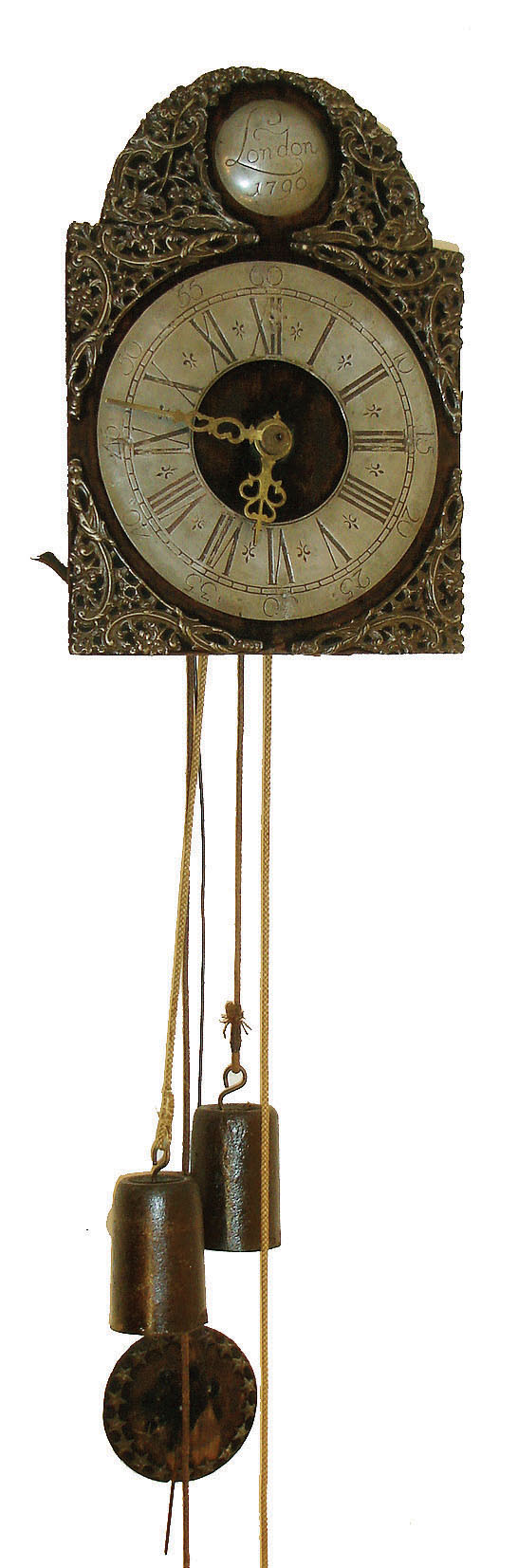 Germany, shield clock, wooden dial with velvet cover and pewter spandrels, boss, and chapter ring, pierced brass hands, wooden 30 hours, time and strike, movement, pendulum also with velvet covering and pewter ornaments, iron weights, c1860 — Antique Clocks Price Guide