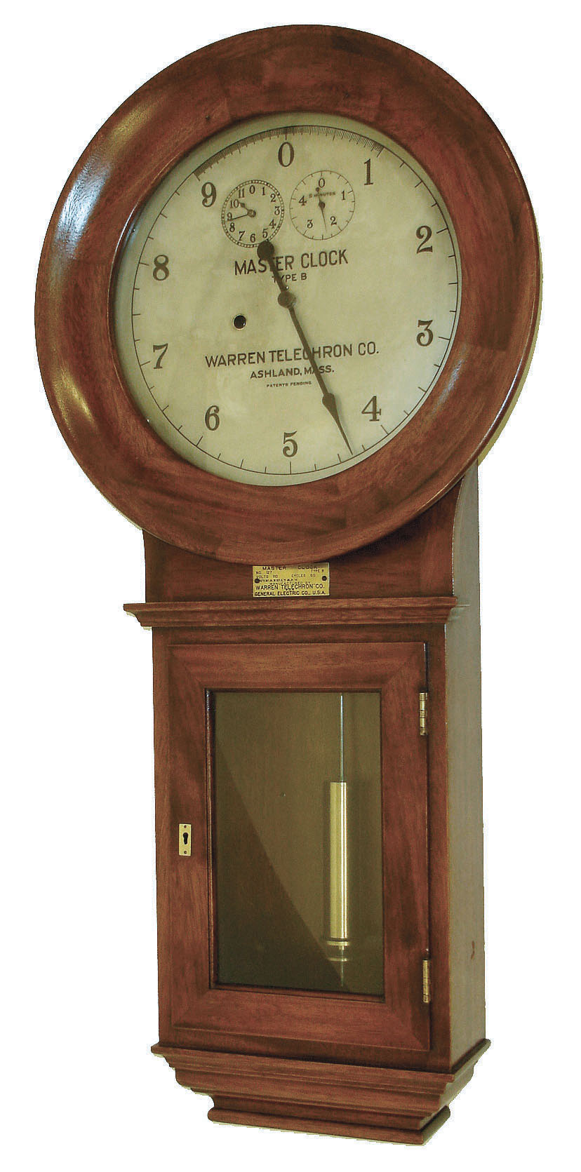 Warren Telechron Co., Ashland, Mass., "Warren B. Master Clock", (No. 127 Frequency Clock) in a walnut case and silvered dial, 110v motor combined with quality spring movement.  Spring movement moves the center hand backwards; electric movement moves it forward, c1925 — Antique Clocks Price Guide