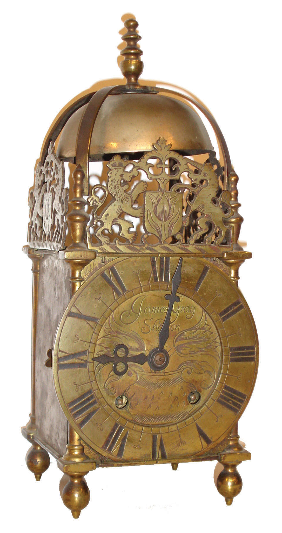 England, lantern clock, brass case with pierced frets, turned columns, feet, and finials, the top with turned finial and a large bell, Roman numeral engraved brass dial, signed "James Gray Shaston", Winterhalder and Hofmeier 8 days, time and strike, movement — Antique Clocks Price Guide
