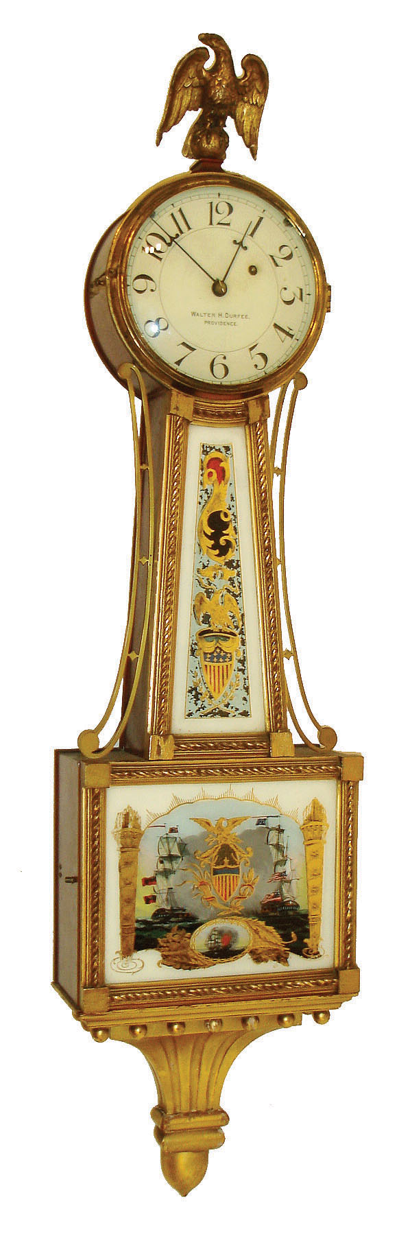Walter Durfee, Providence, Rhode Island, patent timepiece or banjo clock, mahogany case with gilt frames and presentation bracket, lower tablet with battleships, throat glass with gilt eagle and stars and bars shield, case top with gilt composition eagle, signed Arabic numeral white painted dial, steel barbed hands, 8 days, E. Howard &amp; Co. timepiece movement with damascened pendulum, cast iron weight, c1910 — Antique Clocks Price Guide