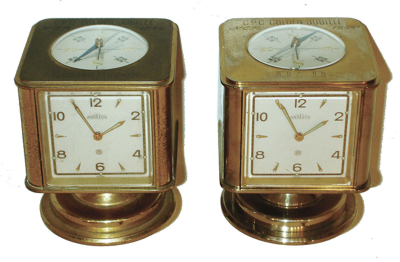 Clocks- 2 (Two): Angelus, Swiss-made swiveling weather stations 8 day timepieces in brass cases with barometers, Celsius &amp; Fahrenheit thermometers, hygrometers and top compasses. Both have "CPC Golden Jubilee NCR 1954" on top. — Antique Clocks Price Guide