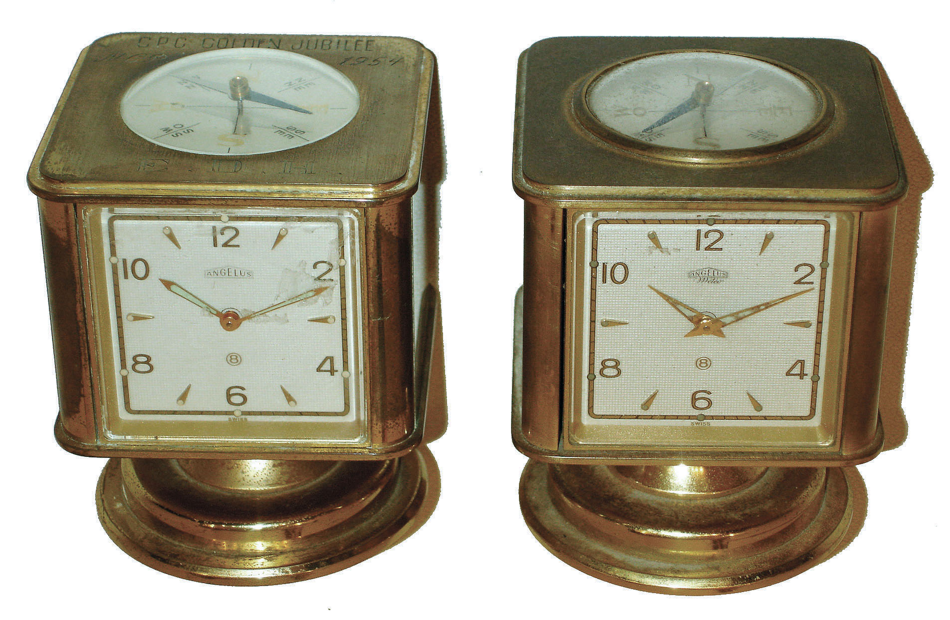 Clocks- 2 (Two): Angelus, Swiss swiveling weather stations in brass cases, 8 day timepieces with barometers, Celsius &amp; Fahrenheit thermometers, hygrometers and top compasses. One has "CPC Golden Jubilee NCR 1954" on top. — Antique Clocks Price Guide