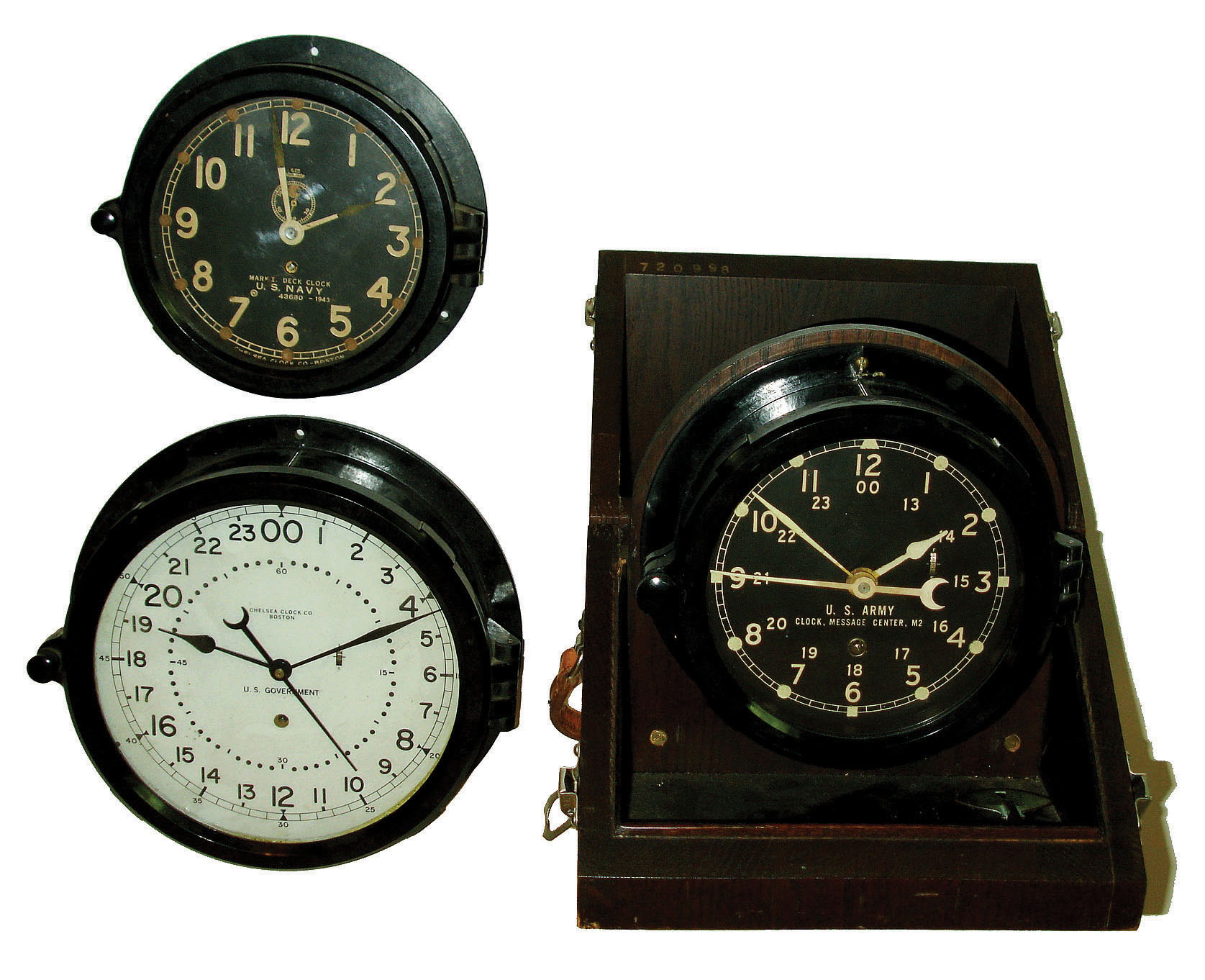 Clocks- 3 (Three) Chelsea Clock Co., Boston, with phenolic cases, 8 day time only, hinged bezel military clocks: U.S. Army Message Center in hinged wood box; U.S. Navy 1943 Mark 1 Deck Clock with 6" dial; U.S. Government with 24-hour 8" white dial. — Antique Clocks Price Guide