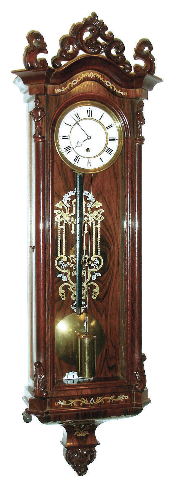 Austria, miniature Vienna regulator, rosewood veneered case with brass and pewter inlays in bottom bracket and backboard, door with acanthus carving at bottom, and with full length sentinels at top, with removable, rococo style scroll carved crest, and leaf and scroll carved finials, Roman numeral white enamel dial, blued steel hands 8 day brass timepiece movement, polished brass pendulum and brass weights, c1860 — Antique Clocks Price Guide