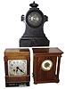 Clocks- 3 (Three) American mantel clocks: American Clock Co., Chicago, Ill. self-winding movement in walnut case, c1905; American Clock Co., New York "Tucker Bronze" iron case 8 days, time and strike, c1875; Ansonia Clock Co., 8 days, time and strike, movement in a 20th century purpose-made oak case with "David E. Lawler" on its base.