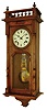 France, walnut cased wall clock, with Morbier iron framed repeating movement, the case top trimmed with a balustrade and glass in the door revealing unique grid iron pendulum, striking the hours on a straight wire gong, and repeating the hour strike 2 minutes later. C.1910