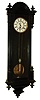 F. Kroeber Clock Co., New York, German made Vienna regulator model, ebonized wooden case in the Vienna style, Roman numeral white enamel dial, brass 8 day timepiece movement, polished pendulum and weight, c1885