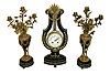 Causard, a Paris, stunning 3 piece blue cobalt porcelain and gilt bronze lyre form clock with candle stands.  The case replete with ornaments in the classical taste, the top with mask of Helios above floral festoon, the pendulum composed of a ring of brilliants with gridiron style rod, and with knife edge suspension above the movement canister and oscillating in full view, gilt bezel with convex beveled glass, Arabic numeral white enamel dial with floral garlands, signed "Causard Hger Du Roy A Paris", gilt lyre form hands, 8 days, time and strike, pendule a Paris movement, signed S. Marti, the candelabras also in cobalt glaze, set with brilliants, and with gilt classical ornament, the candle arms with rose leaves and buds, the sockets of open rose form, c1890