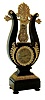 France, lyre clock, ebonized wooden case with gilt ornament, Roman numeral silvered dial with engine turning, blued steel Breguet style hands, gridiron style pendulum with scallop shell ornament suspended above the movement and behind the lyre strings, case back with purpose made cover for the exclusion of dust, 8 days, time and strike, pendule a Paris movement, c1840