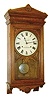 Seth Thomas Bundy time recorder wall clock, oak case with lower half missing, and the bottom attached to the shortened case, Roman numeral paper dial, steel spade hands, damascened nickel pendulum, 15 or 30 day timepiece movement, c1900
