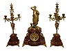 France, Bernoux, quality 3-piece "Conical Pendulum" clock set, the case of dark red mottled marble with bronze statue, case feet and yarn basket, and with matching candelabra with bronze arms and accents, c1880