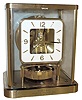 Jaeger - LeCoultre, Swiss "Atmos" 13-jewel glass and gold-plated brass perpetual mantel clock #634697 with 1988 presentation plate