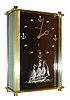 Jaeger - LeCoultre, Switzerland, small desk or nightstand clock, model# 2163, rectangular brass case with brushed finish, lucite front with wave and anchor hour markers, and with 3 dimensional tall ship below, dial signed "LeCoultre Swiss", gilt hands, case sides with black panels, 8 day time and alarm movement, with separate music box playing 2 tunes, c1965