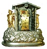 Mayer, Germany, 30 hours, novelty clock in a nickeled, cast case, the oval base with rocks and foliage, with a log cabin above, a gnome on the left is preparing to kill a chicken, while on the right side, a woman and man embrace, the white enamel Roman numeral dial, gilt hands, and a panting dog emerging from a window above the clock, his tongue moving in and out as the clock runs, tall rectangular plate movement with counterpoised pallet arbor and with attachment for dog tongue, back plate signed "Mayer", c1870