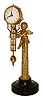 Fuji, Japan, swinging timepiece figure of cupid seated atop a fluted column and supporting the clock in his right hand, the figure with gold finish and mounted to a black painted metal base, polished brass clock case, Arabic numeral metal dial signed "Fuji", polished brass hands, 8 day timepiece movement, c1970