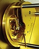 Gubelin, Switzerland, inclined plane clock, time only, gravity powered 15 jewel gilt movement with platform escapement also showing the date, silvered dial with applied gilt Roman numerals and blued steel day pointer, blued steel hands, contained in a gilt drum style case, the incline of scrolled iron with applied gilt acanthus leaf ornament, the front with engraved days of the week, all resting on gilt ball feet, c1980