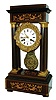 Coppey, Cherbourg, France, 8 days, time and strike, portico clock with pendule a Paris movement, gilt gridiron style pendulum with central mask. rosewood case with light wood stringing and marquetry, ebonized moldings and feet, the 4 columns with gilt capitals and bases, gilt bezel in the rococo style, Roman numeral white enamel dial signed "Coppey a Cherbourg", fancy gilt hands, c1860