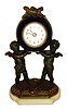 Germany, 30 hours, time only, small desk or nightstand clock, Cobalt blue ceramic case supported by two putti on a gilt and marble base surmounted by a trophy consisting of a quiver, wreath, and torch, Arabic numeral white enamel dial, luminous hands, c1910