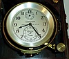 Hamilton Watch Co., Lancaster, Penn., model 21 marine chronometer, 14 jewel key wind and set, straight line damascened nickel plate movement, with spring detent escapement and chronometer balance with helical hairspring, in a gimbaled brass bowl with screw bezel, and Arabic numeral, metal dial with wind indicator, black painted steel spade and poker hands, contained in mahogany inner and outer boxes with brass hardware, serial #2E4133, c1941