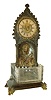 France, an unusual table clock with fountain, patinated bronze case in the Gothic taste, the base containing a cut a cut glass reservoir, the front corners with gryphon feet, case front with niche, trimmed with cast foliate ornament and grotesque mask, a twisted glass rod which rotates under power of a concealed movement simulates water pouring from the mouth of the mask, frosted glass dial with painted Roman numerals, 30 hour Swiss verge movement, c1850