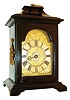 Austria, small bracket clock, ebonized wooden case with ogee molded base and pagoda top with gilt ring carrying handle, case sides with figural gilt mounts, gilt shield shaped dial with engraving, matted center, and Roman numeral applied silvered chapter ring, a single blued steel hand, and silvered alarm set ring, round brass 30 hour fusee timepiece with verge escapement and alarm, turned baluster form pillars, and engraved, watch style back cock and with pendulum fixed to pallet arbor, c1790.