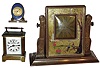 Clocks- 3 (Three) 30 hour desk: New Haven "Kenneth" carriage with Elks dial; "Claudine" Juvenia Swiss miniature enamel with white marble base; "CBKZA" easel-form gold painted Asian theme; early 20th century