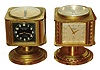 Clocks- 2 (Two): Angelus, Swiss-made in brass swiveling cases. Both 8 day timepiece 5-dial units with top compass, barometer, Celsius & Fahrenheit thermometer and hygrometer. One with black dials retailed by "Milton A. Fuller, Inc., Palm Beach"; the silvered clock's dial marked "Meteo"; c1960