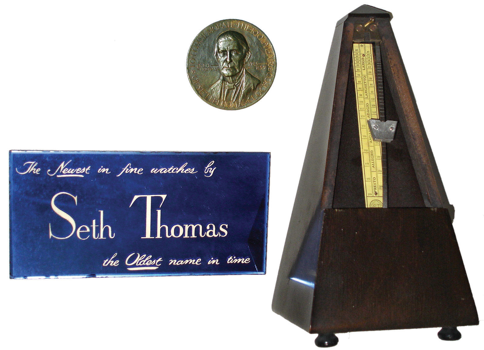 Clocks- 2 (Two) Seth Thomas, Thomaston, Conn., and Seth Thomas accessories: (1) Seth Thomas Clock Co. ÓMinsterÒ oak 15 day, time and strike, ÓCityÒ mantel clock, c1883; (2) Seth Thomas Clock Co., Plymouth Hollow, Conn., NY Style diminutive 4 Column shelf clock with a spring driven, 8 days, time and strike, movement in a mahogany case, c1850; (3) metronome, glass watch sign, and 100-year commemorative medal with Seth Thomas and father time. — Antique Clocks Price Guide