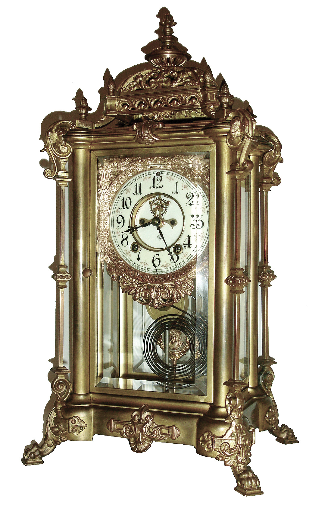 Ansonia Clock Co., New York, EXCELSIOR, crystal regulator, with cast female bust pendulum, and with multi color, creamy porcelain dial with red decorations between the Arabic numerals, and with open escapement on the dial, c1904 — Antique Clocks Price Guide