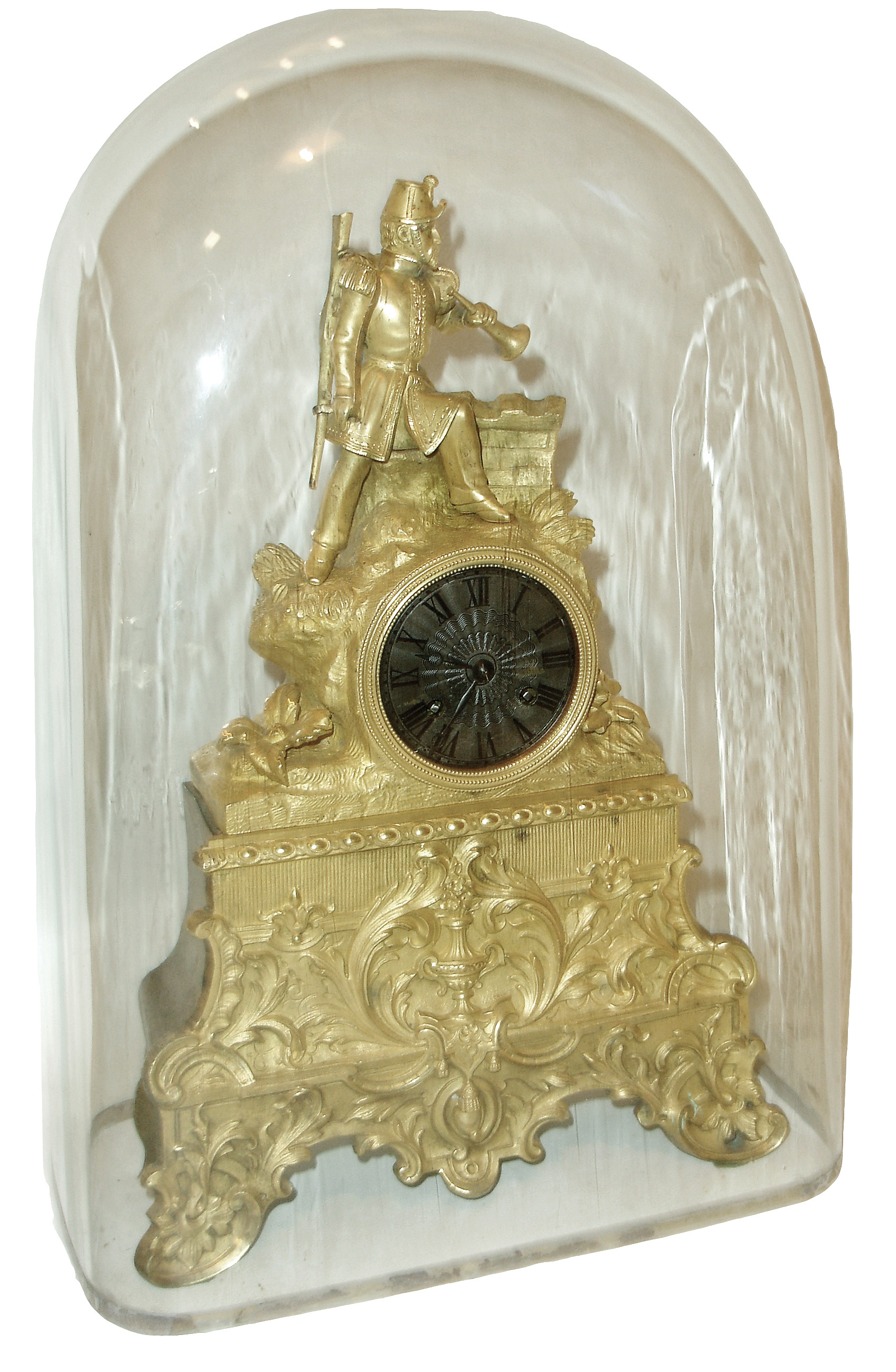 French, dore bronze figural clock, ARMY, an officer in full dress with bugle in left hand and a percussion rifle over his left shoulder, standing near a parapet, the clock itself tastefully off-center, the whole above a base of urns, swags and scrolls, and with a good old rectangular glass dome, c1840 — Antique Clocks Price Guide