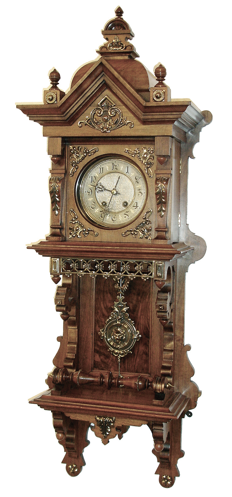 Lenzkirch, Germany, walnut open well or ÓFreischwingerÒ, with built-in top and with approx 24 pieces of brass decoration, and the fancy cast pendulum depicting a lionÕs head, the well made movement bearing the Lenzkirch logo and serial Nr. 860461, Fancy embossed brass dial with gilt highlights, c1888 — Antique Clocks Price Guide
