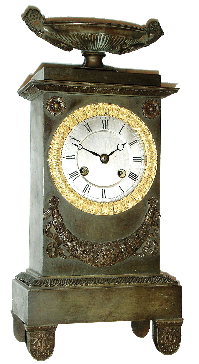 France, Empire period, bronze clock, 8 days, vertical monument motif surmounted by a large urn, and with silvered dial and gilt bezel, silk thread suspended pendulum on well made movement, c1830 — Antique Clocks Price Guide