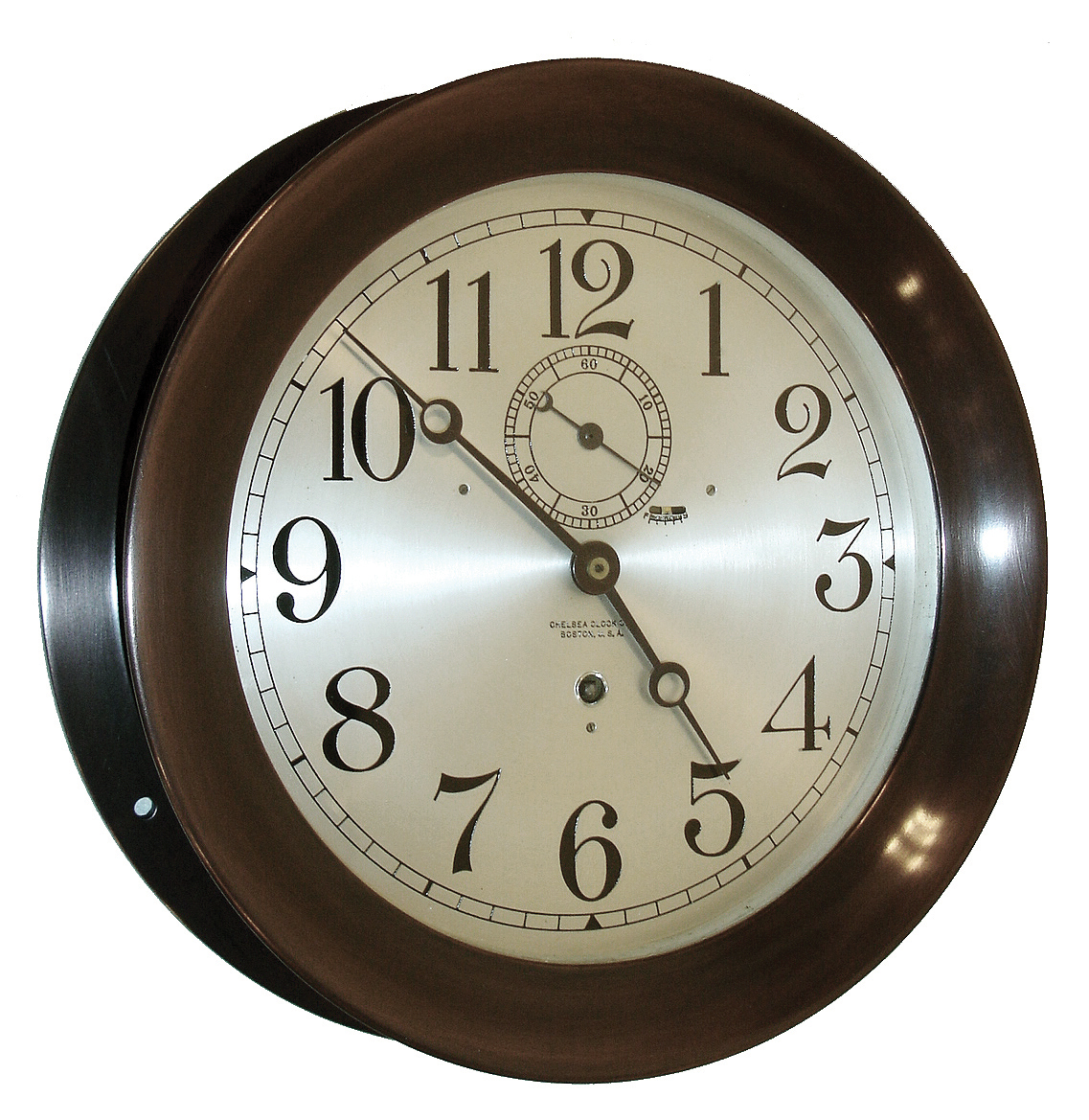 Chelsea Clock Co., Chelsea, Mass., ÒPilot HouseÓ, wall clock, 8 days, time only, spring driven movement in a patinated bronze case with an 8 1/2Ò Arabic numeral silvered dial, serial No. 128192, c1920. — Antique Clocks Price Guide
