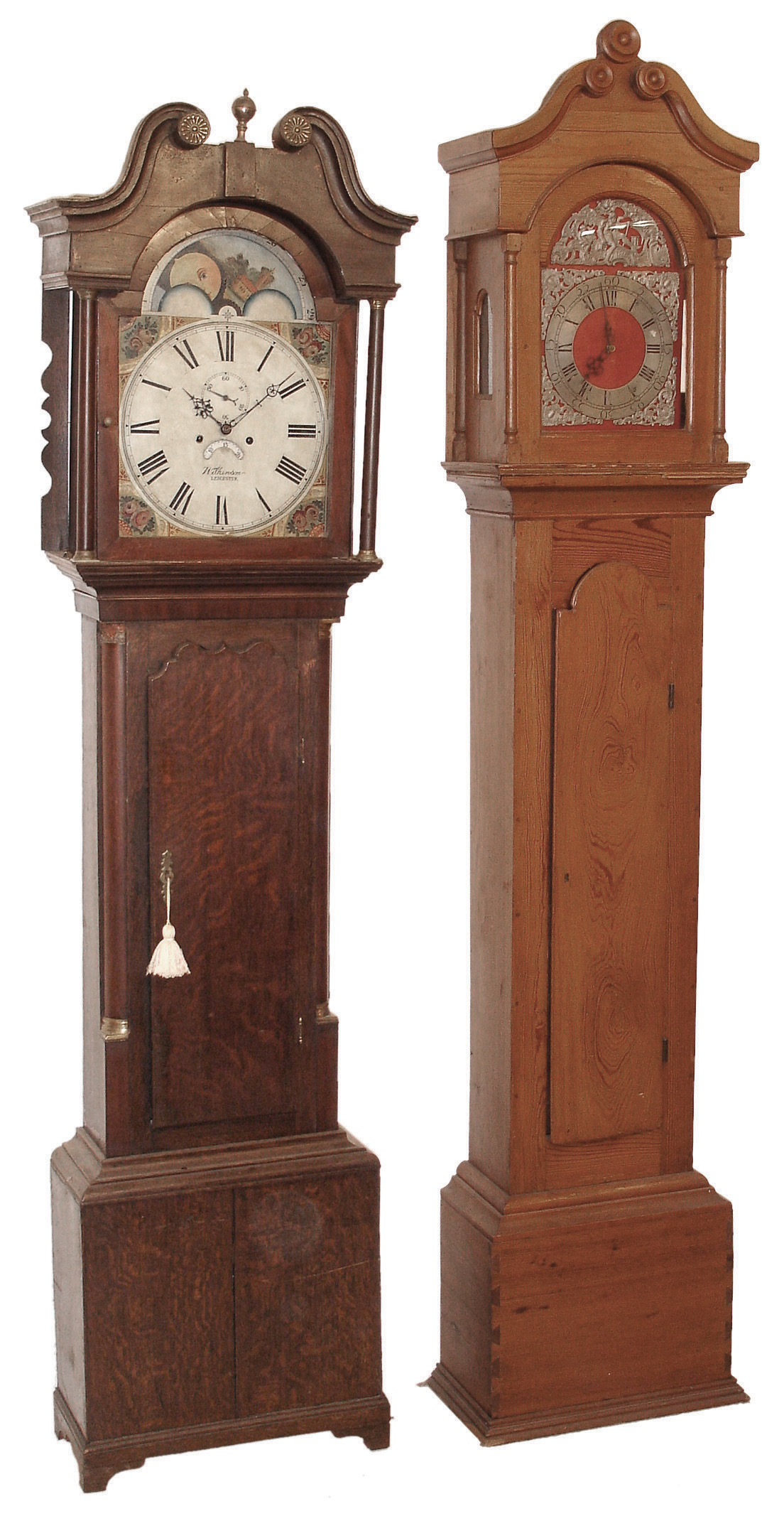 English tall case clocks- 2 (Two): (1) Wilkinson, Leicester, England 8 days, time, strike and calendar, weight driven movement in a dark oak case with false moon phase dial, c1820; (2) Unsigned, 30 hours, time and strike, endless chain movement in a hard pine case with red painted dial, silvered chapter ring and applied pewter spandrels and boss c1790 — Antique Clocks Price Guide